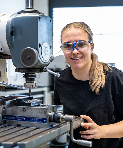 Trainee drills a hole for a dowel pin with a milling machine