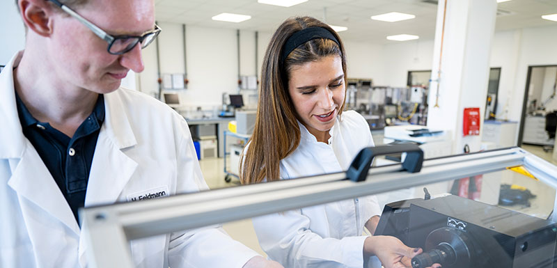 Two ADMEDES employees perform a torsion test in the test laboratory